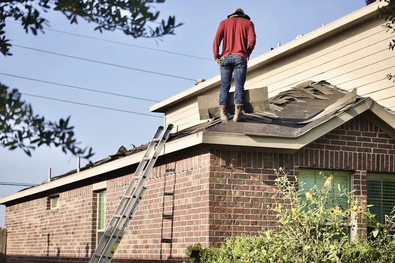 Professional roofer working on a residential roof in Holiday Villa